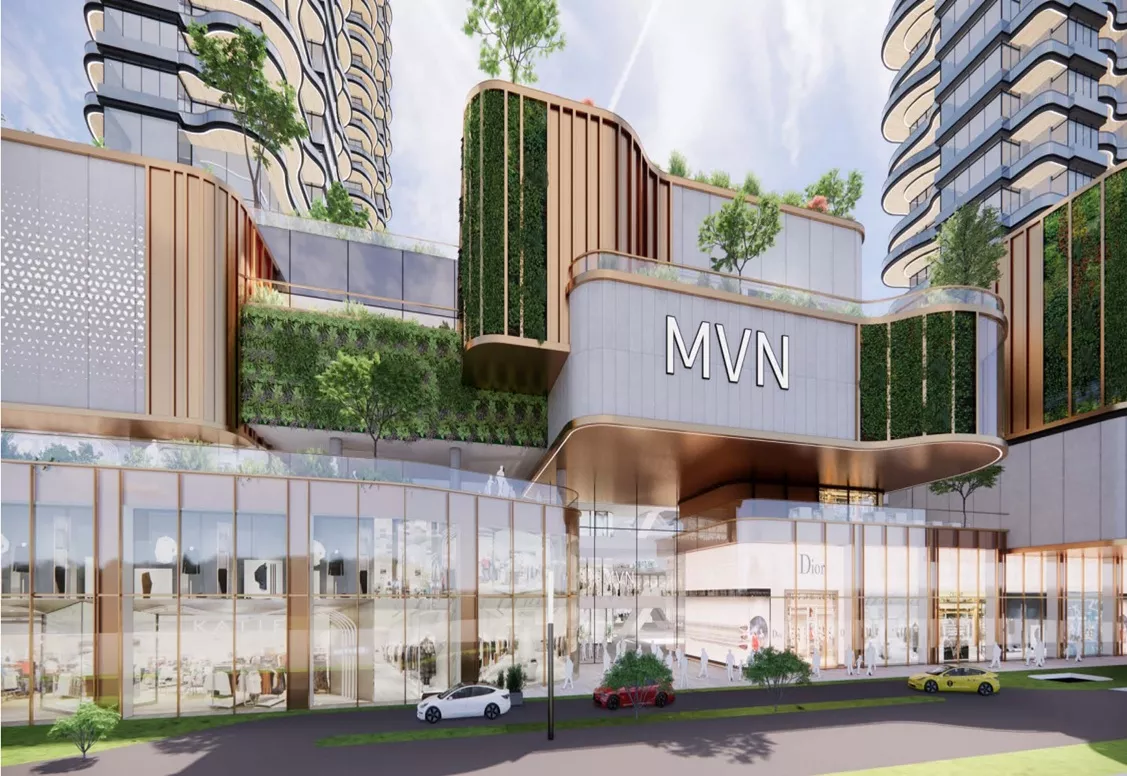 Exterior view of MVN Mall with modern glass facade, green terraces, and high-rise towers above